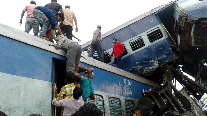 Local residents look for survivors on the wreckage of train carriages after an express train derailed near the town of Khatauli in the Indian state of Uttar Pradesh on August 19, 2017. Ten people were killed and dozens injured when an express train derailed in north India on August 19, an official said.Emergency workers were pulling people out of mangled, upended carriages after 14 coaches derailed near Muzaffarnagar district in Uttar Pradesh state, some 130 kilometres (80 miles) from New Delhi.   / AFP PHOTO / -
