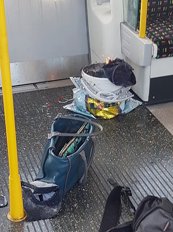 A handout picture obtained from the twitter user @sylvainpennec shows a white container burning inside a London Underground tube carriage at Parsons Green underground tube station on September 15, 2017. More than 20 passengers were injured, some suffering severe burns, in an early morning explosion on a London Underground train in what police described as a "terrorist incident,"  the fifth attack in six months in Britain. Emergency services were called around 8:20 am (0720 GMT) after the explosion at Parsons Green station in a leafy southwestern suburb which police counter-terror chief Mark Rowley said had been caused by an "improvised explosive device." / AFP PHOTO / @sylvainpennec / HO / ===RESTRICTED TO EDITORIAL USE - MANDATORY CREDIT "AFP PHOTO / HO / @sylvainpennec - NO MARKETING NO ADVERTISING CAMPAIGNS -  NO ARCHIVES - DISTRIBUTED AS A SERVICE TO CLIENTS