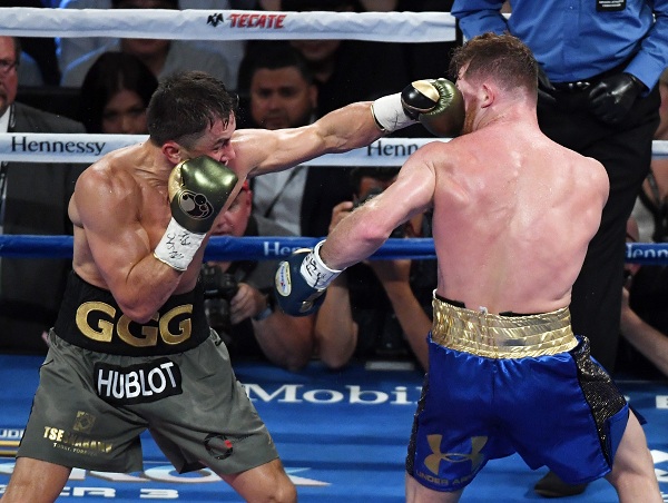 LAS VEGAS, NV - SEPTEMBER 16: Gennady Golovkin (L) thows a left at Canelo Alvarez in the fourth round of their WBC, WBA and IBF middleweight championship bout at T-Mobile Arena on September 16, 2017 in Las Vegas, Nevada. The boxers fought to a draw and Golovkin retained his titles.   Ethan Miller/Getty Images/AFP