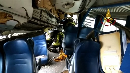 This handout picture released by the Italian Vigili del Fuoco shows firemen working in a train coach after a train derailment, on January 25, 2018 near Milan. At least two people were killed and 10 seriously injured when a packed regional train derailed near Milan in northern Italy, emergency services said. She said the incident happened at around 7 am (0600 GMT) near the Milan suburb of Segrate. The cause was not immediately clear. / AFP PHOTO / Vigili del Fuoco / HO / RESTRICTED TO EDITORIAL USE - MANDATORY CREDIT "AFP PHOTO / VIGILI DEL FUOCO" - NO MARKETING NO ADVERTISING CAMPAIGNS - DISTRIBUTED AS A SERVICE TO CLIENTS