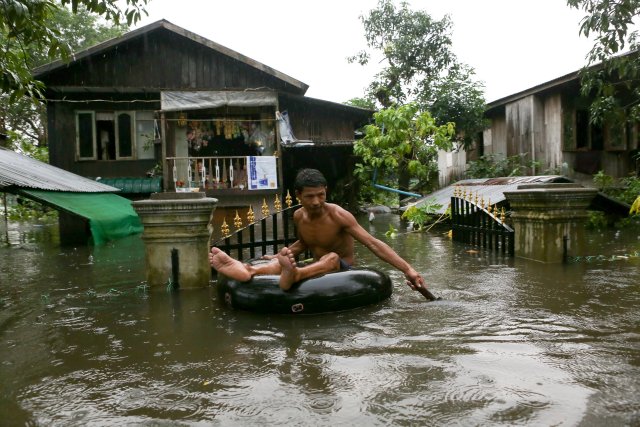 A man travels through a flooded street in Bago, Myanmar, July 27, 2018. Picture taken July 27, 2018. REUTERS/Stringer NO RESALES. NO ARCHIVES.