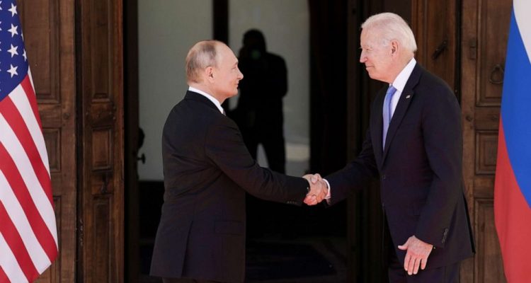 Biden and Putin shake hands.