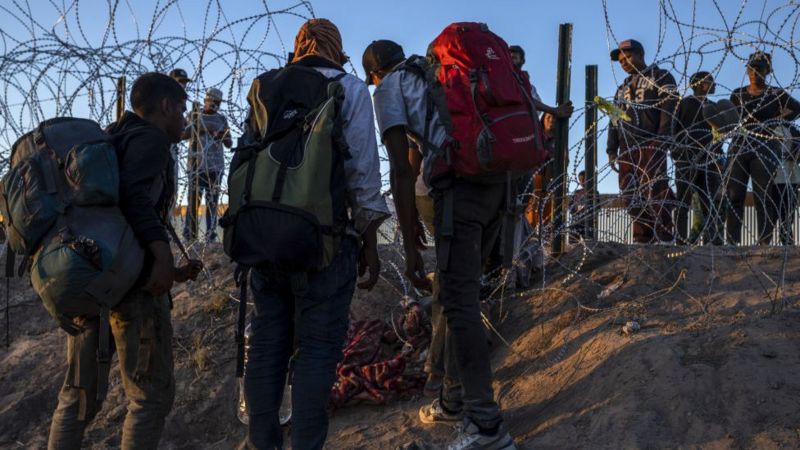 Migrantes en el muro
